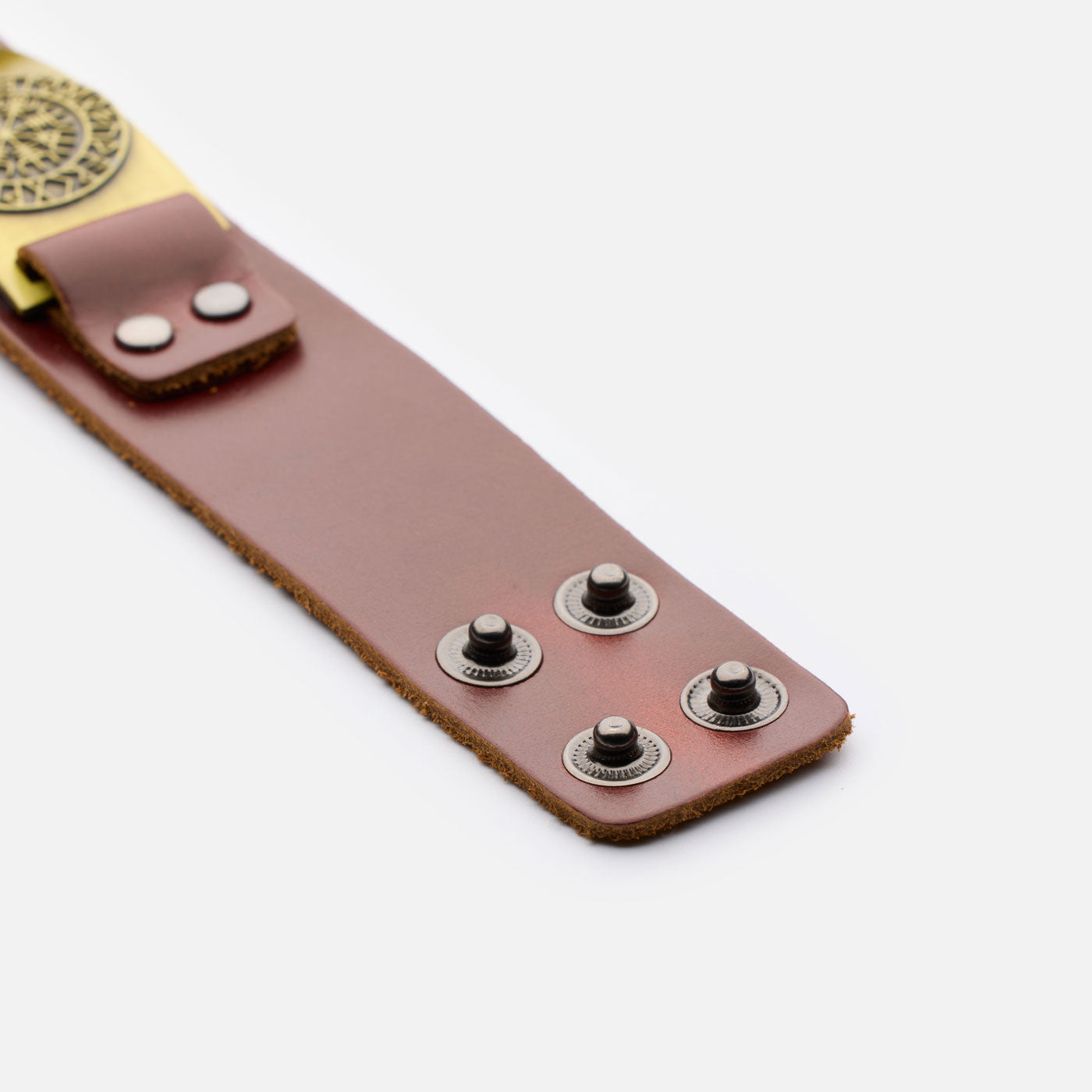 Flat open view of brown leather bracelet with four metal snaps for adjustable sizing and strong hold.