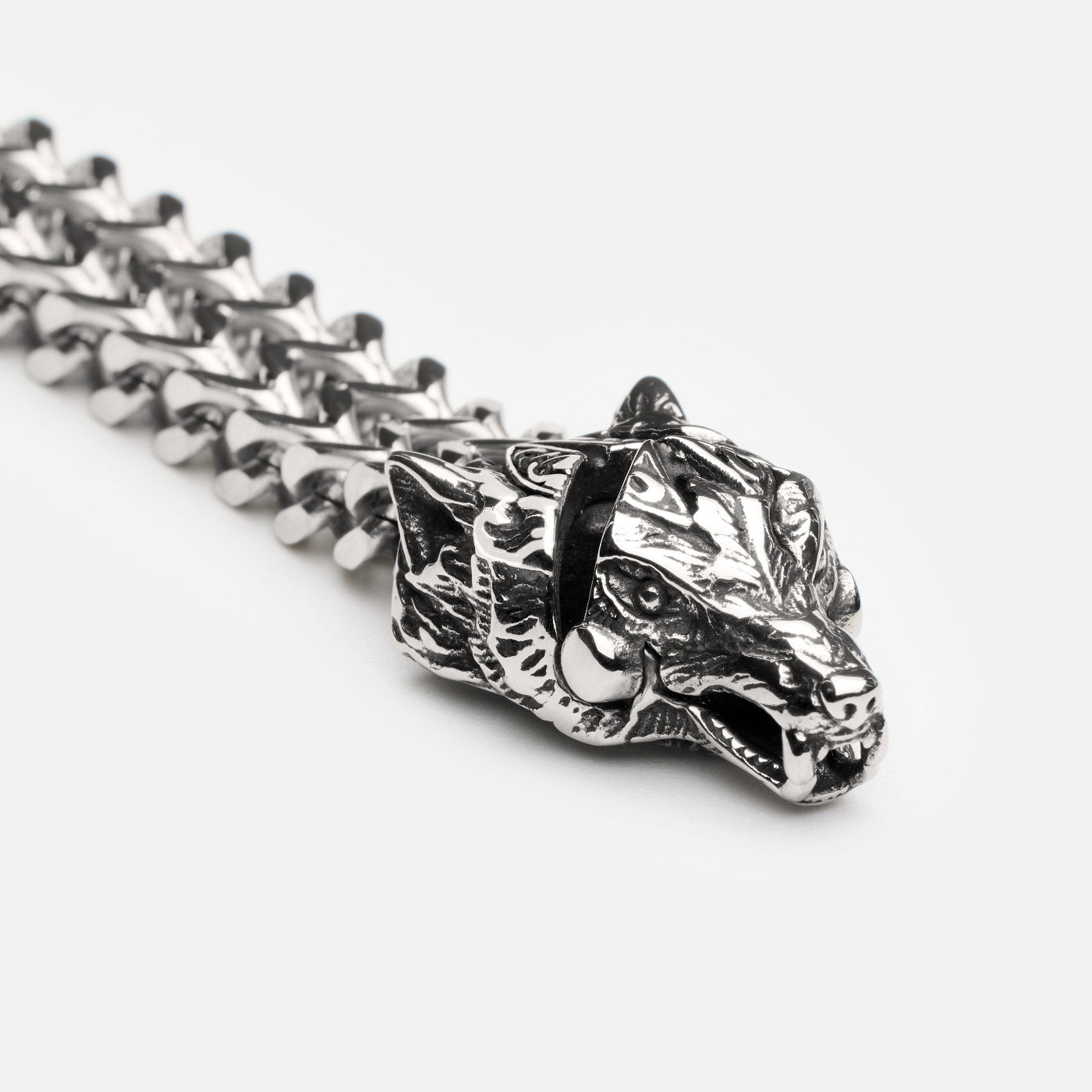 Macro shot of the upgraded Fenrir wolf head clasp in stainless steel, showing intricate Norse detailing and sharp craftsmanship on Viking-style bracelet by Odin Trinkets.