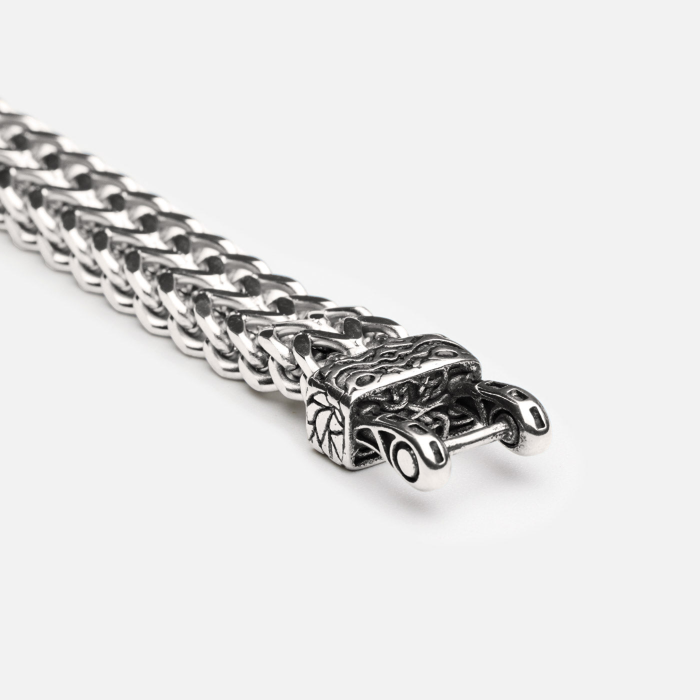 Close-up view of the secure clasp mechanism on the Fenrir wolf bracelet by Odin Trinkets, showing Norse-inspired engravings and thick chain links in stainless steel.