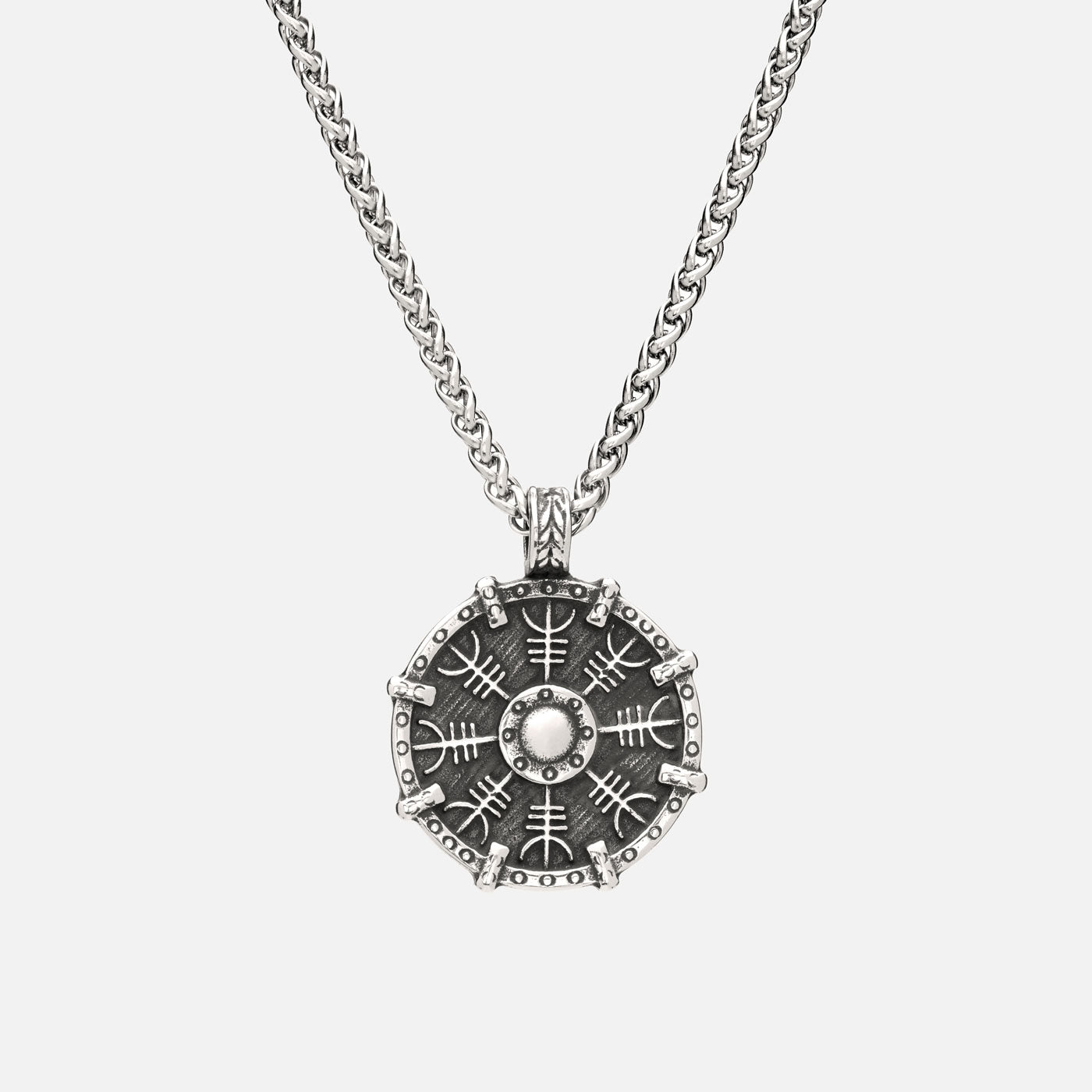 Viking Helm of Awe necklace with shield-shaped pendant, featuring Ægishjálmur symbol and worn on stainless steel curb chain.