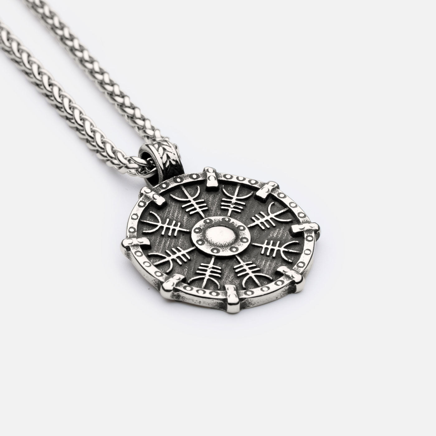 Side view of Helm of Awe pendant with engraved protection sigil and bold Viking shield design on a classic curb chain necklace.