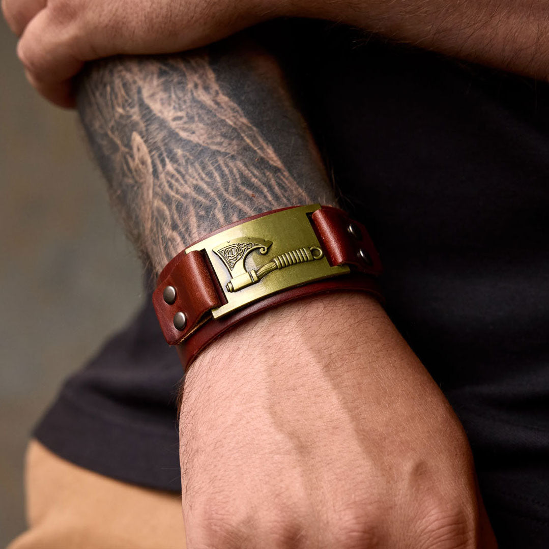 Viking axe bracelet in brown leather worn on wrist – Norse-themed men's accessory