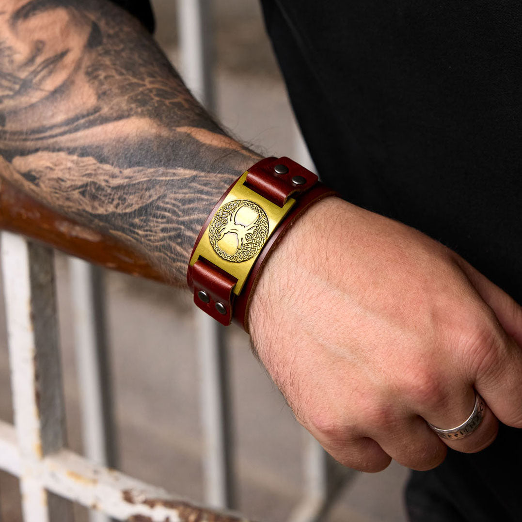 Close-up of man’s wrist wearing Yggdrasil bracelet in brown with golden bronze plate