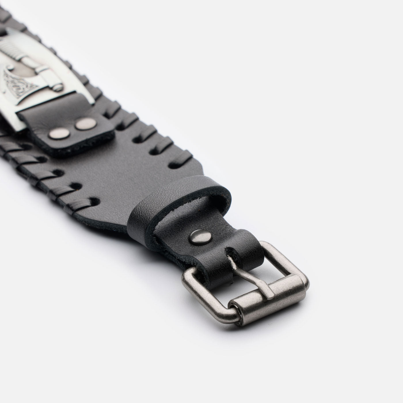 Close-up of the black leather bracelet’s adjustable buckle system and detailed stitching