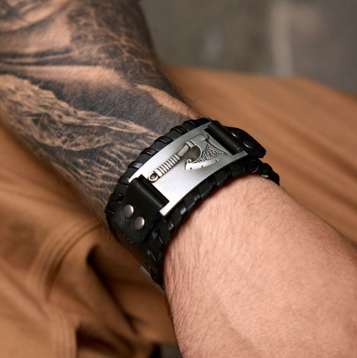 Black Viking axe bracelet with Nordic engraving worn on the wrist