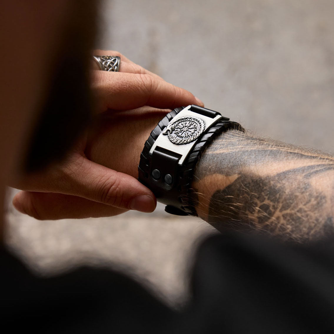 Black Viking bracelet with Jormungandr and Vegvísir worn on wrist – Norse heritage in everyday style