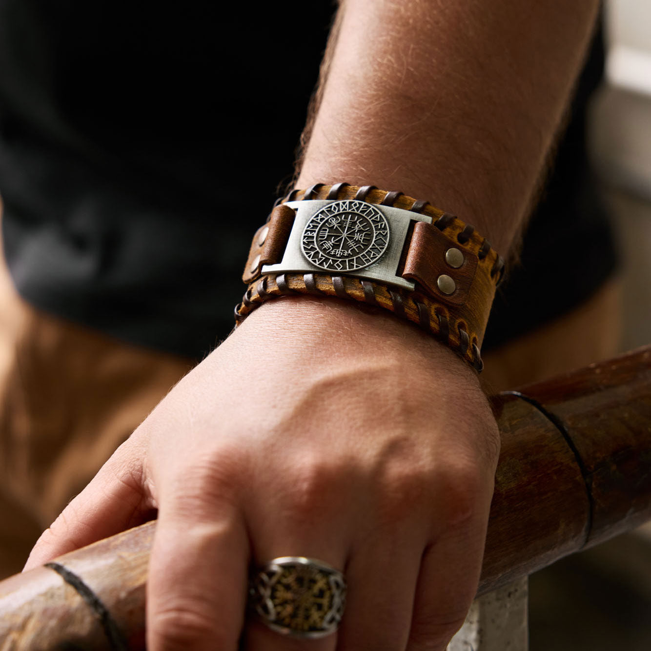Brown Viking leather bracelet with Vegvisir symbol worn on wrist, featuring detailed Nordic design