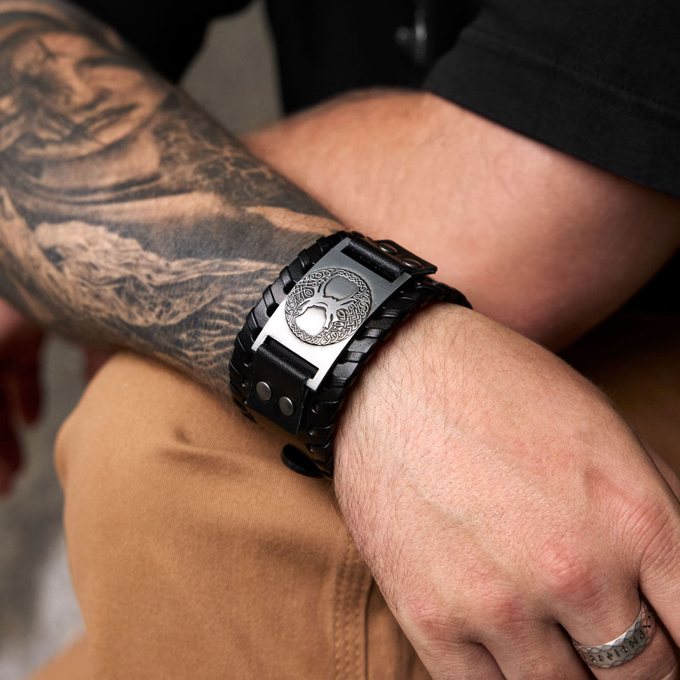 Yggdrasil leather bracelet in black – worn on tattooed wrist for Viking style look