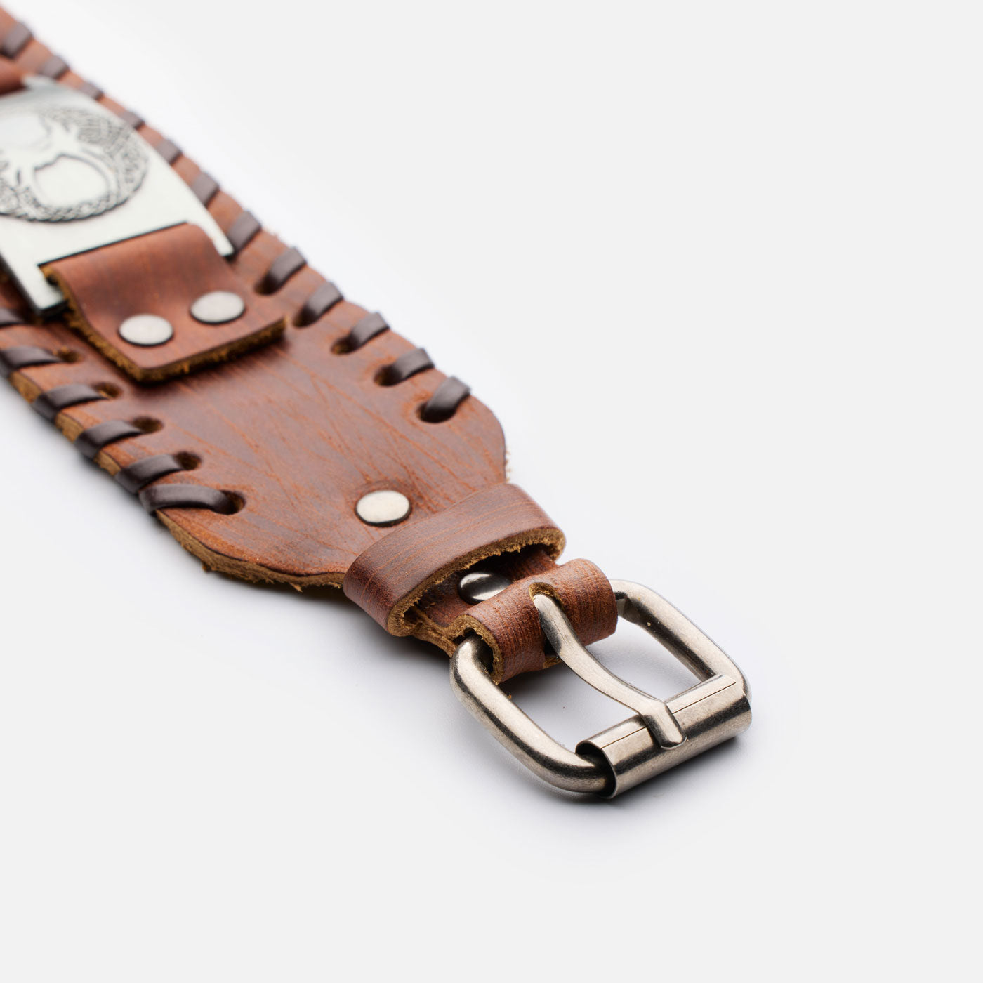 Celtic Yggdrasil symbol on metal plate – close-up of brown leather wristband
