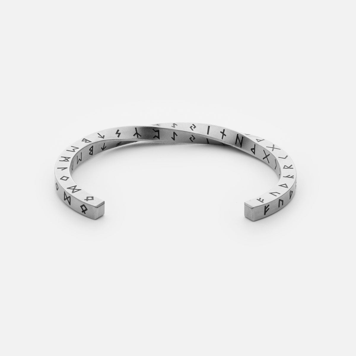 Silver stainless steel Rune Bracelet from Odin Trinkets, featuring engraved Elder Futhark runes in a minimalist open cuff design, symbolizing ancient Norse wisdom and Viking heritage.