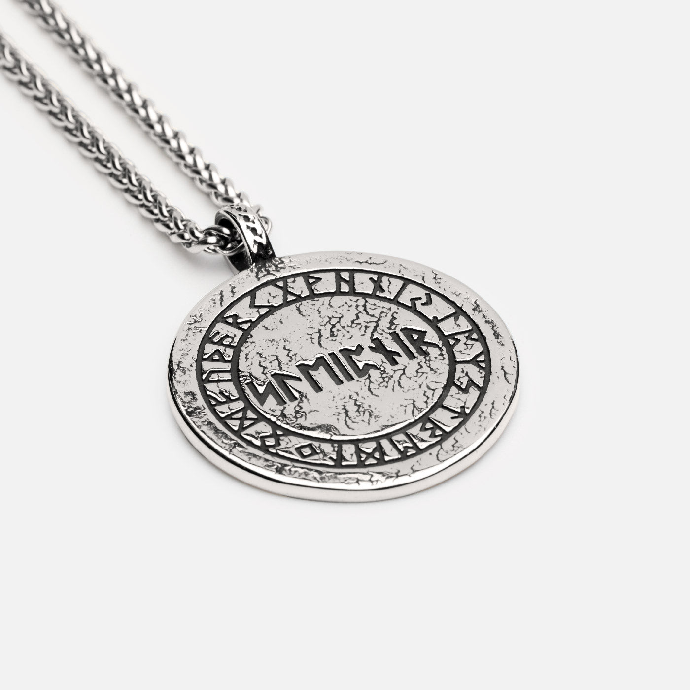 Backside of the Sleipnir Viking pendant with engraved Elder Futhark runes and ancient Norse inscription on a silver medallion.