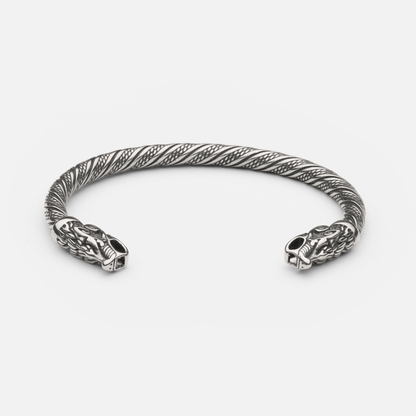 Wolf bracelet with intricate twisted design, featuring two detailed wolf heads at either end. Made of high-quality stainless steel, this piece exudes a fierce, mythical aura, capturing the power and symbolism of the wolf in Norse mythology."