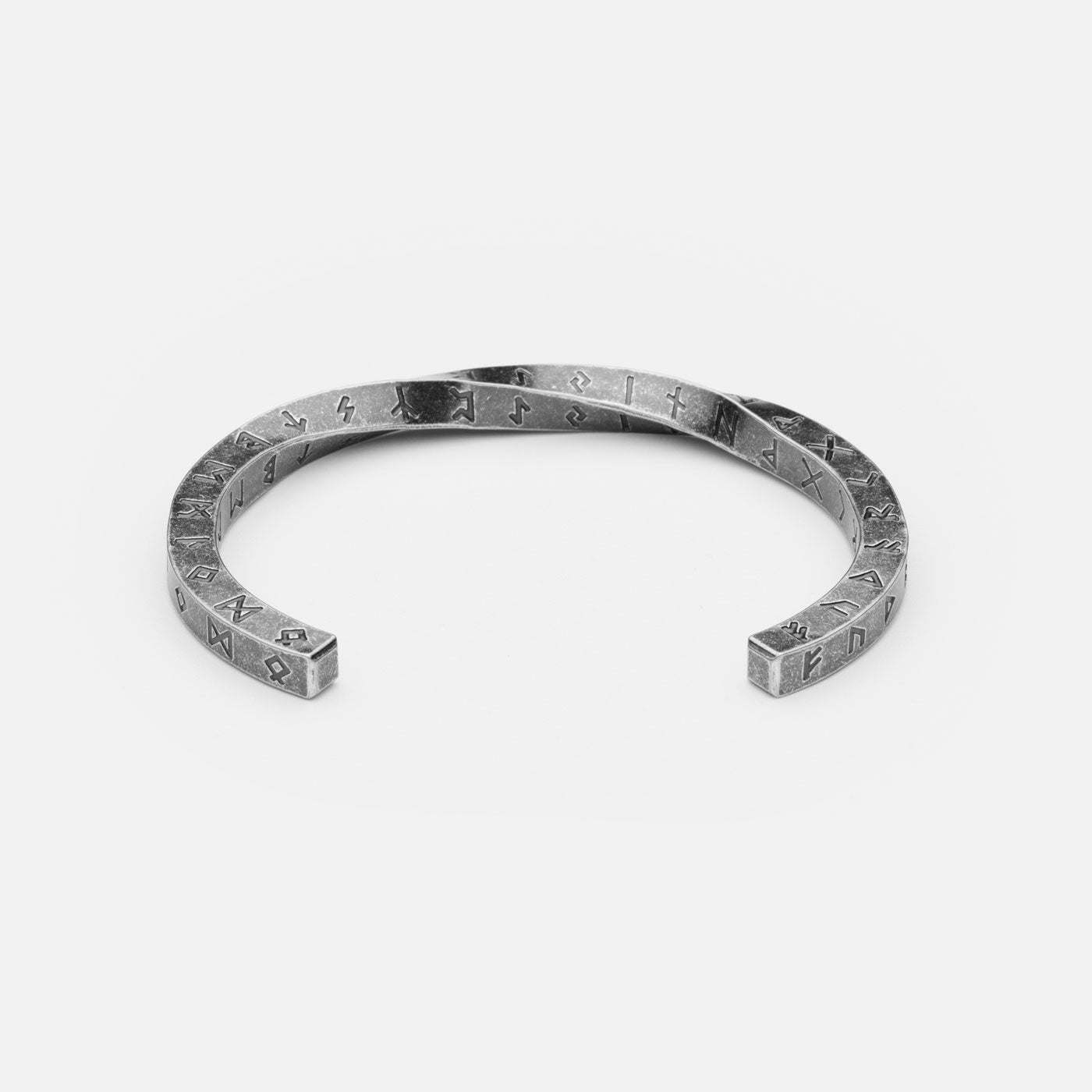 Close-up of the Elder Futhark Rune Bracelet from Odin Trinkets, crafted from stainless steel with deep-engraved runes in a rustic Viking cuff design, embodying Norse heritage and ancient wisdom.