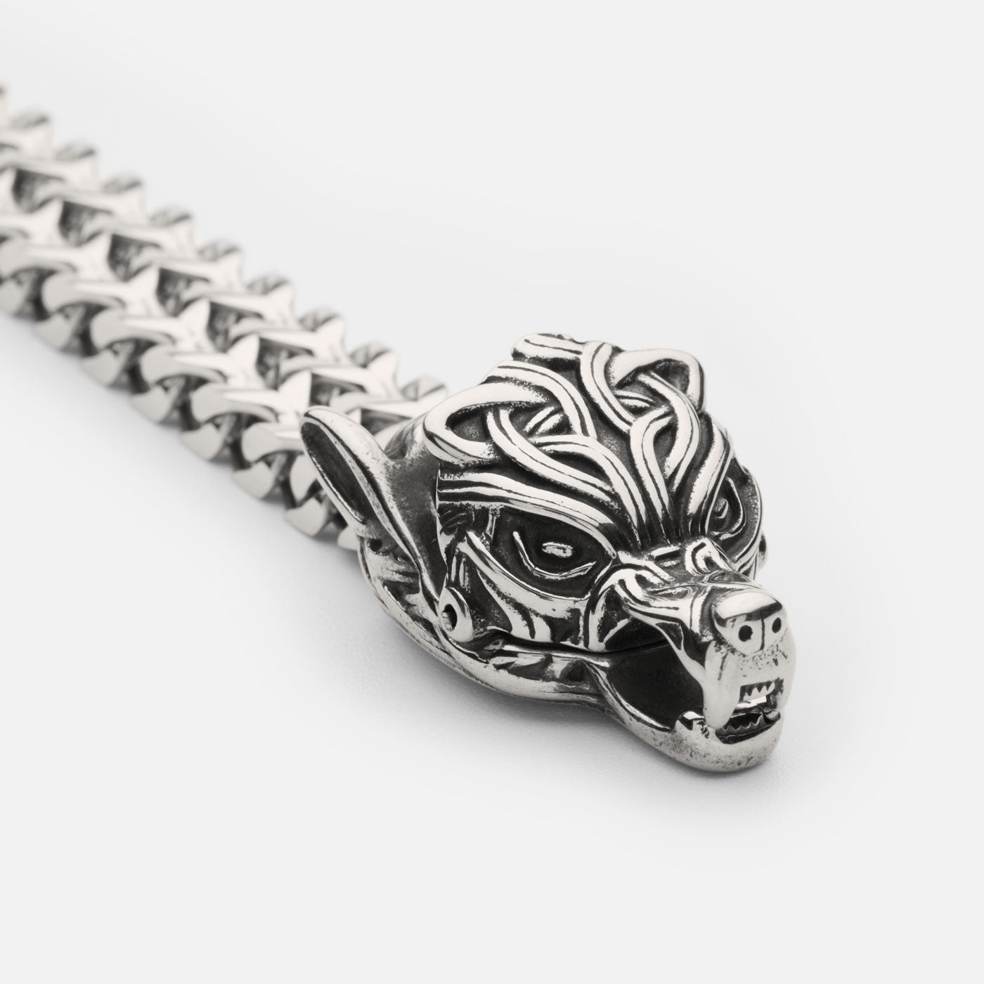 Close-up of a stainless steel Fenrir wolf bracelet from Odin Trinkets, featuring an intricately detailed wolf head clasp inspired by Norse mythology, symbolizing strength and destiny.