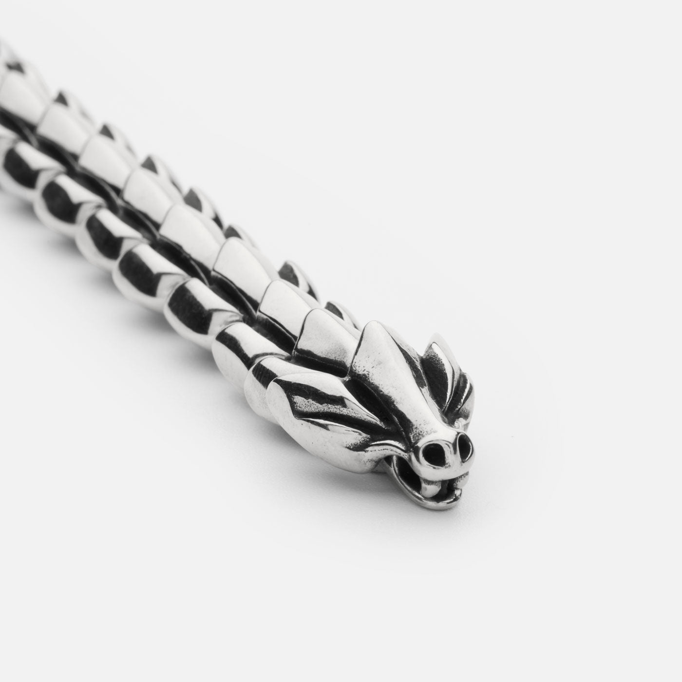 Close-up of the stainless steel Jörmungandr bracelet from Odin Trinkets, showcasing the intricately designed serpent head clasp inspired by the Norse World Serpent.