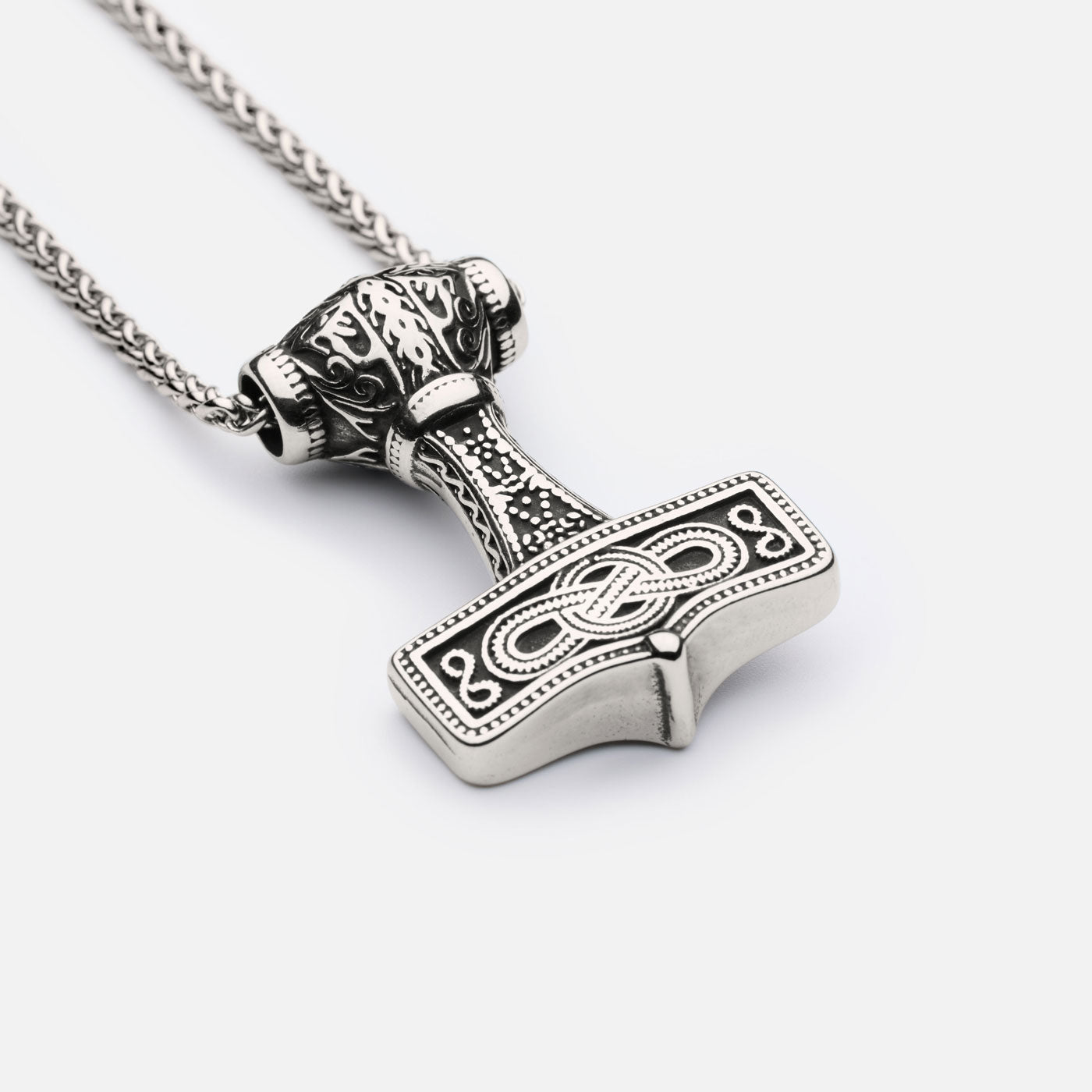 Detailed shot of the Mjölnir of Asgard pendant highlighting the engravings and hammerhead structure