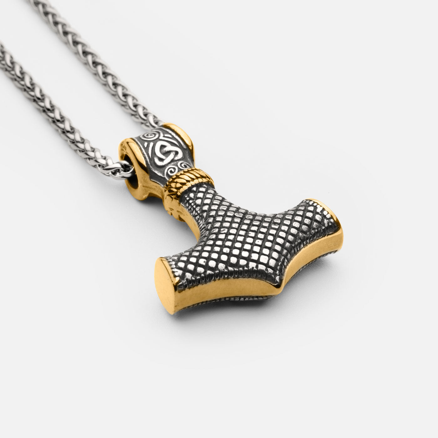 Back view of the stainless steel Mjölnir pendant in gold and silver from Odin Trinkets, showcasing a textured grid pattern and intricate Norse engravings on a simple yet bold Viking chain.