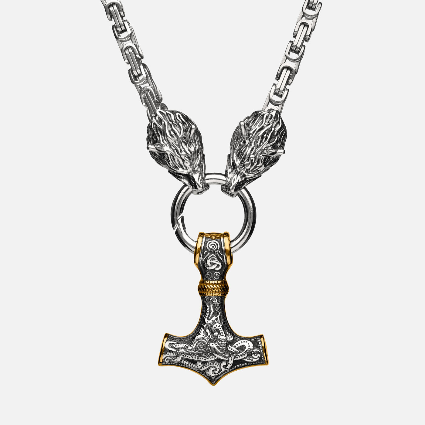 Front view of the stainless steel Mjölnir pendant in gold and silver from Odin Trinkets, featuring intricate Viking engravings, Geri & Freki wolf head clasps, and a bold Norse King’s chain.
