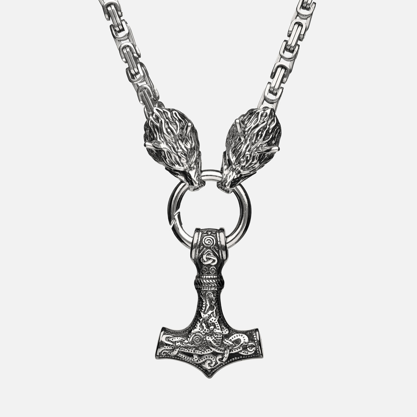 Front view of the stainless steel Mjölnir pendant in silver from Odin Trinkets, featuring intricate Viking engravings, Geri & Freki wolf head clasps, and a bold Norse King’s chain.