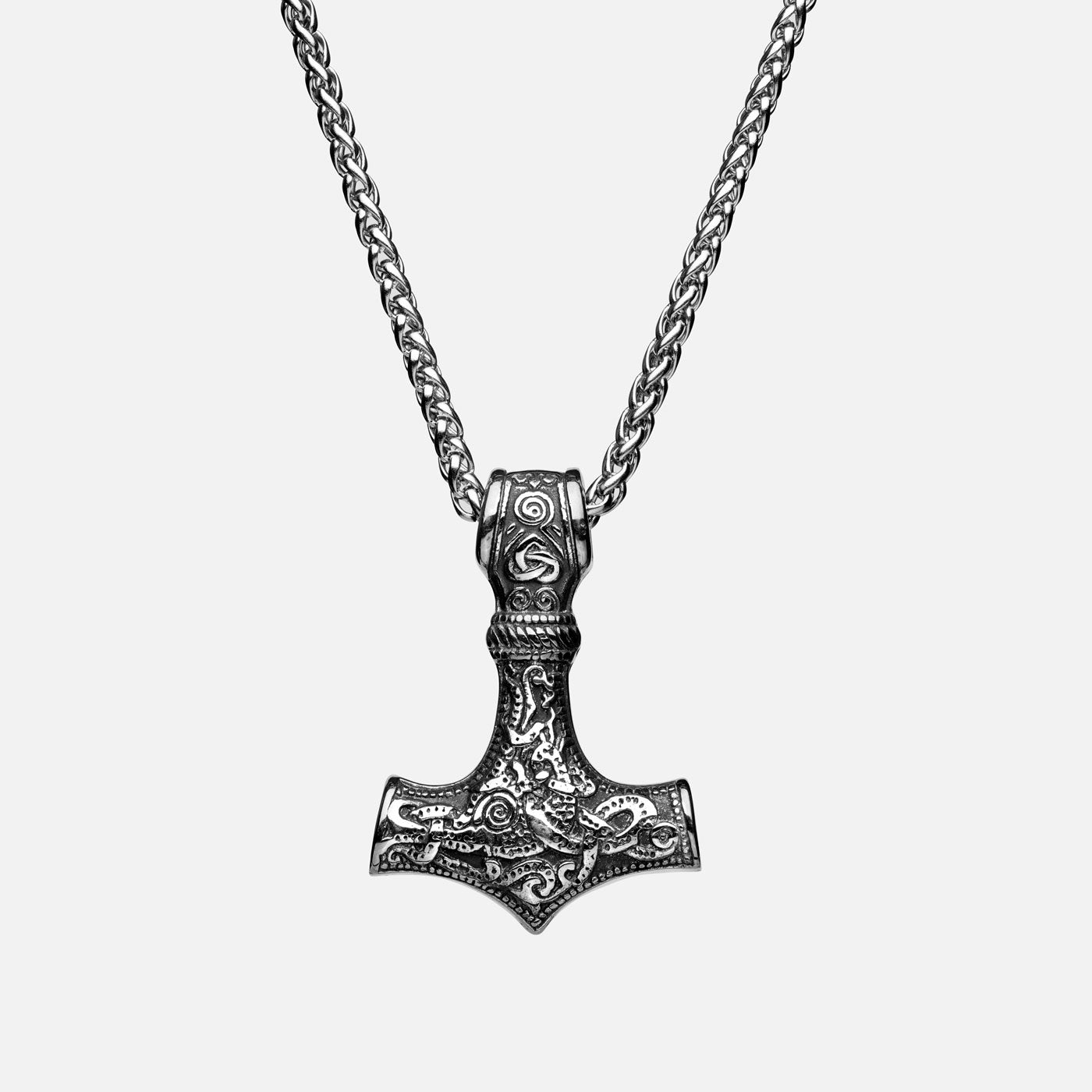 Front view of the stainless steel Mjölnir pendant in silver from Odin Trinkets, featuring intricate Viking engravings and a simple yet bold chain, symbolizing Thor’s legendary hammer.