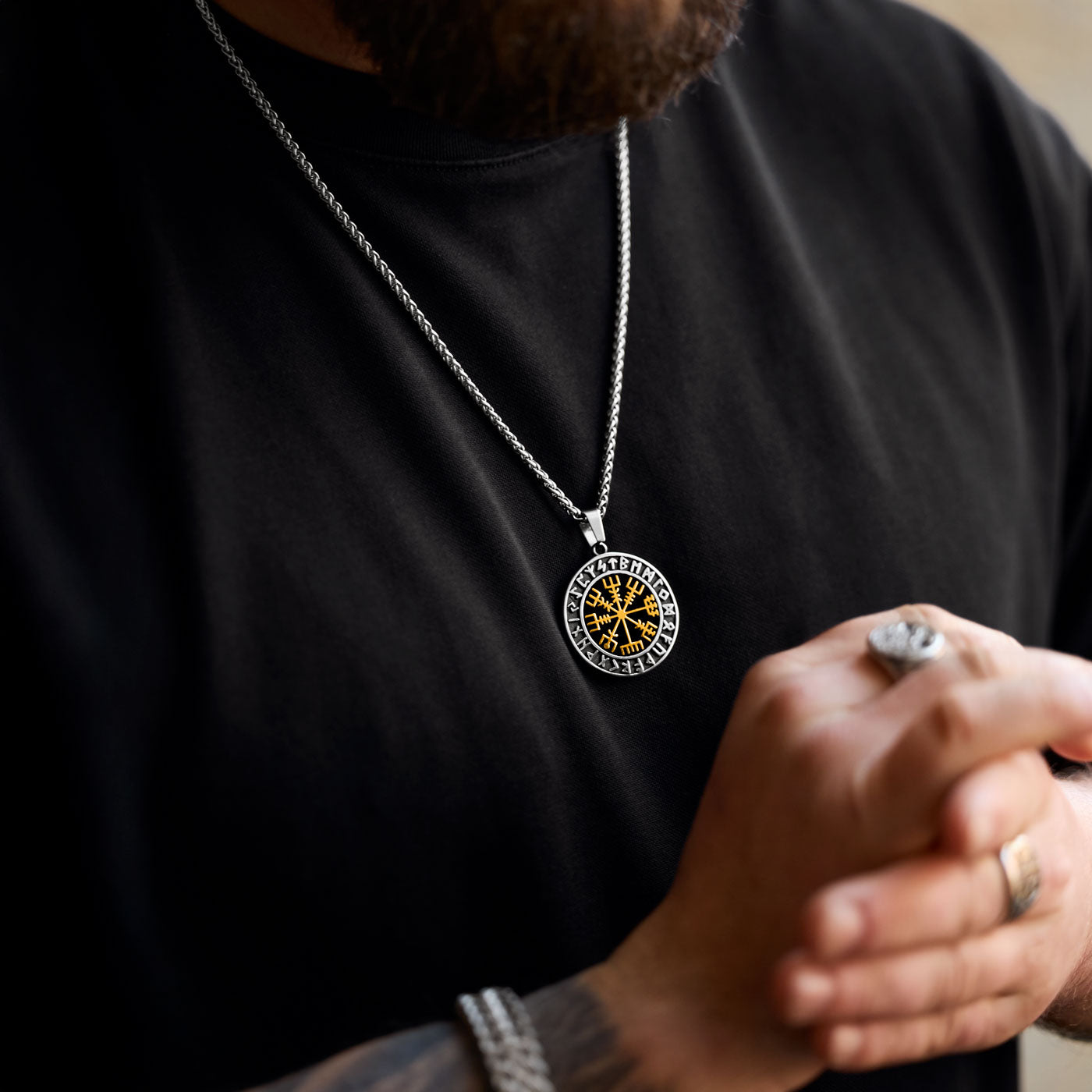 Powerful gold Vegvisir pendant necklace with Elder Futhark runes, symbolizing guidance and protection, worn confidently as part of an expressive Viking-inspired look – exclusive to Odin Trinkets.