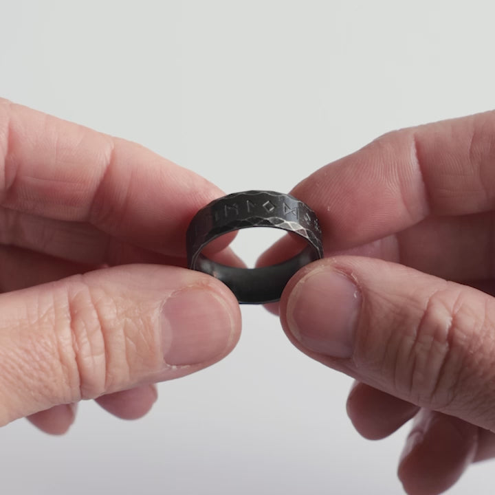 Close-up video of a stainless steel rune ring with a dark, antique finish, engraved with Elder Futhark runes. A bold Viking ring embodying mysticism, strength, and Norse heritage. Designed for those who honor the wisdom of the past—crafted with character by Odin Trinkets.