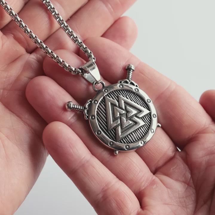 Odin Trinkets close-up video of silver stainless steel Viking necklace featuring the Valknut symbol with shield and crossed swords, Norse mythology inspired jewelry for men