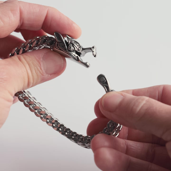 Close-up video of a stainless steel Fenrir bracelet, showcasing its intricate wolf head clasp and bold Viking-inspired design. This Norse mythology bracelet symbolizes strength and ferocity, captured in detail to highlight its craftsmanship – a statement piece from Odin Trinkets.