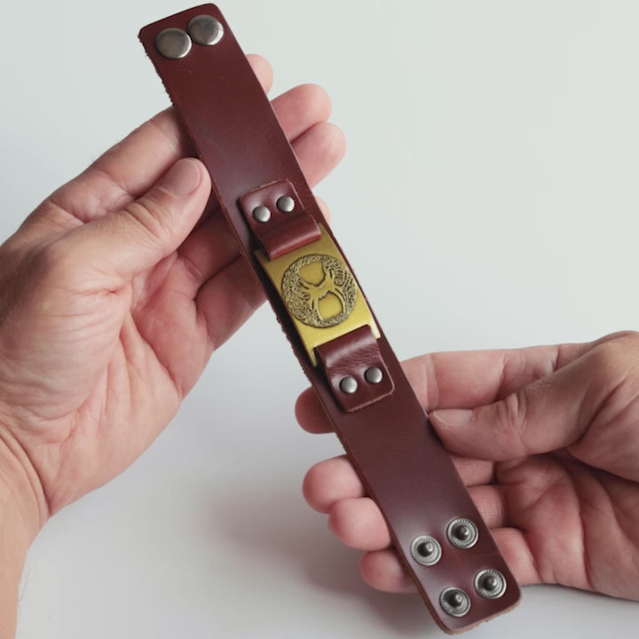 Close-up video of Odin Trinkets close-up video of brown leather Viking bracelet featuring the Yggdrasil tree of life symbol, a powerful design from Norse mythology representing strength and connection