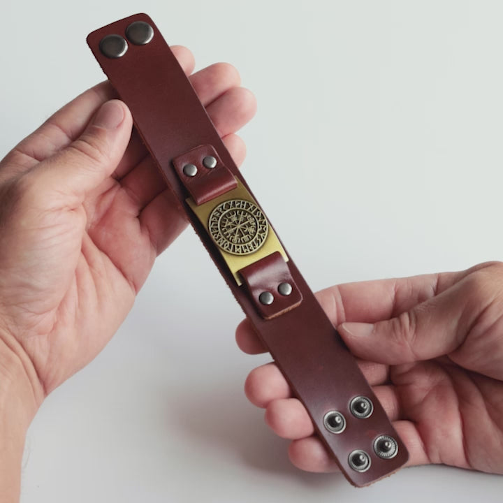 Close-up video of Odin Trinkets brown leather bracelet with detailed Vegvisir compass design, inspired by Norse mythology and worn as a Viking symbol of protection and guidance