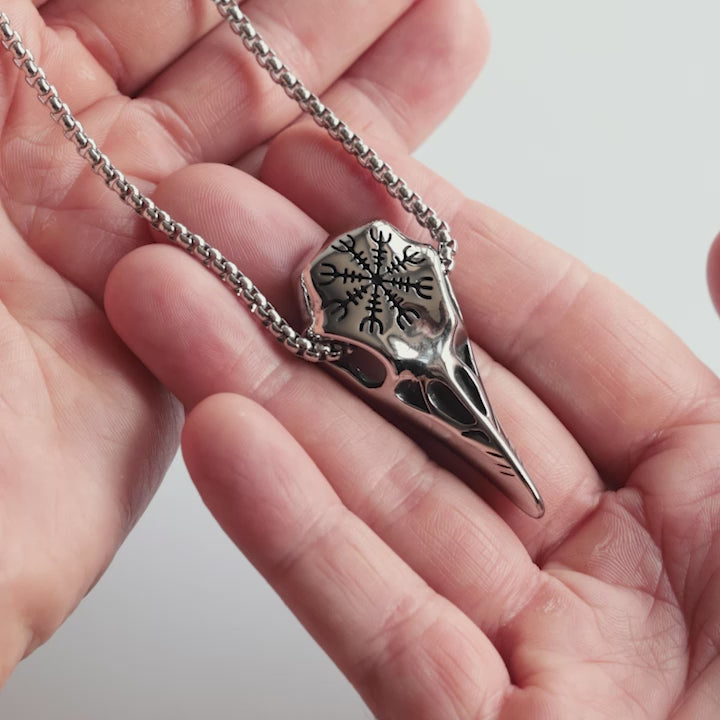 Odin Trinkets close-up video of silver stainless steel Viking raven skull necklace featuring the Vegvisir compass symbol from Norse mythology, bold jewelry design for men