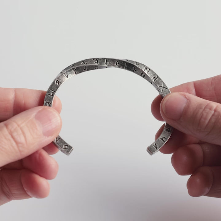 Close-up video of a stainless steel rune bracelet, engraved with the Elder Futhark runes. A minimalist yet powerful Viking cuff symbolizing wisdom, protection, and connection to Norse heritage. A timeless piece crafted for those who embrace ancient symbols—designed by Odin Trinkets.