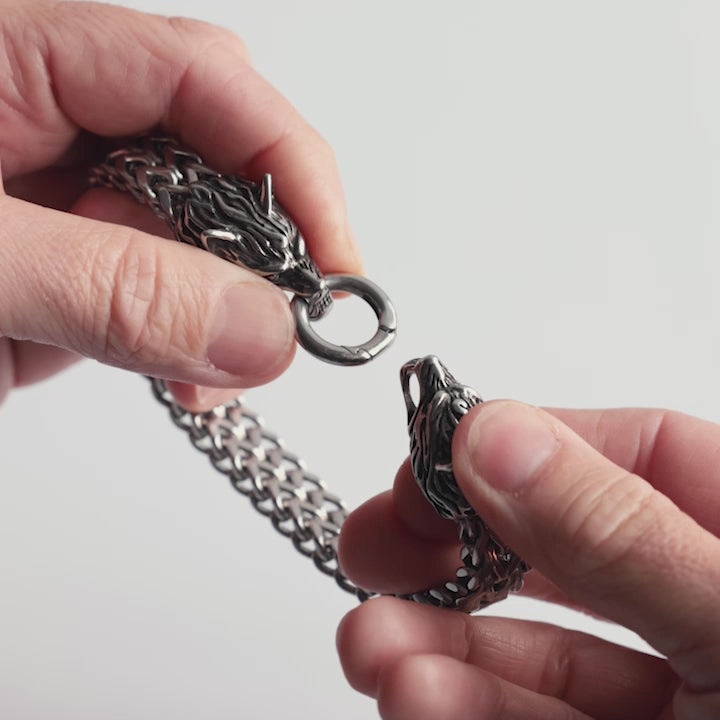 Close-up video of a stainless steel Geri and Freki bracelet, featuring two intricately detailed wolf heads as a clasp. Inspired by Norse mythology, this Viking bracelet symbolizes strength, loyalty, and Odin’s legendary companions. The video showcases its bold design and craftsmanship—an iconic piece from Odin Trinkets.
