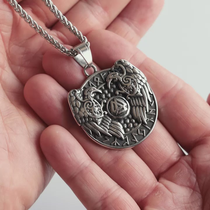 Odin Trinkets close-up video of silver stainless steel Viking necklace featuring Odin’s ravens Hugin and Munin with runic circle and Valknut symbol, Norse mythology inspired jewelry for men