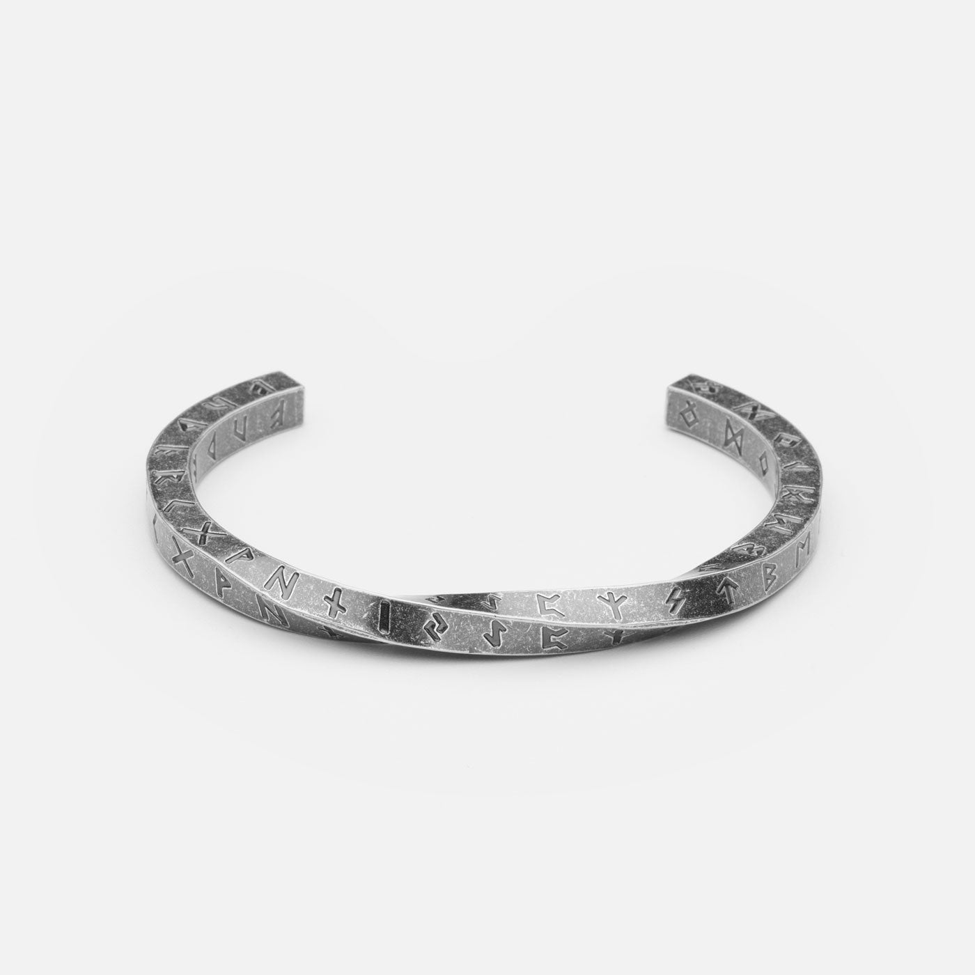 Stainless steel Rune Bracelet from Odin Trinkets, featuring engraved Elder Futhark runes in a minimalist open cuff design, symbolizing ancient Norse wisdom and Viking heritage.