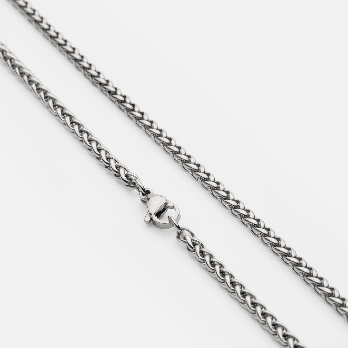 Close-up of the stainless steel Viking chain necklace in silver from Odin Trinkets, featuring a durable woven design and a sturdy lobster clasp for secure wear.