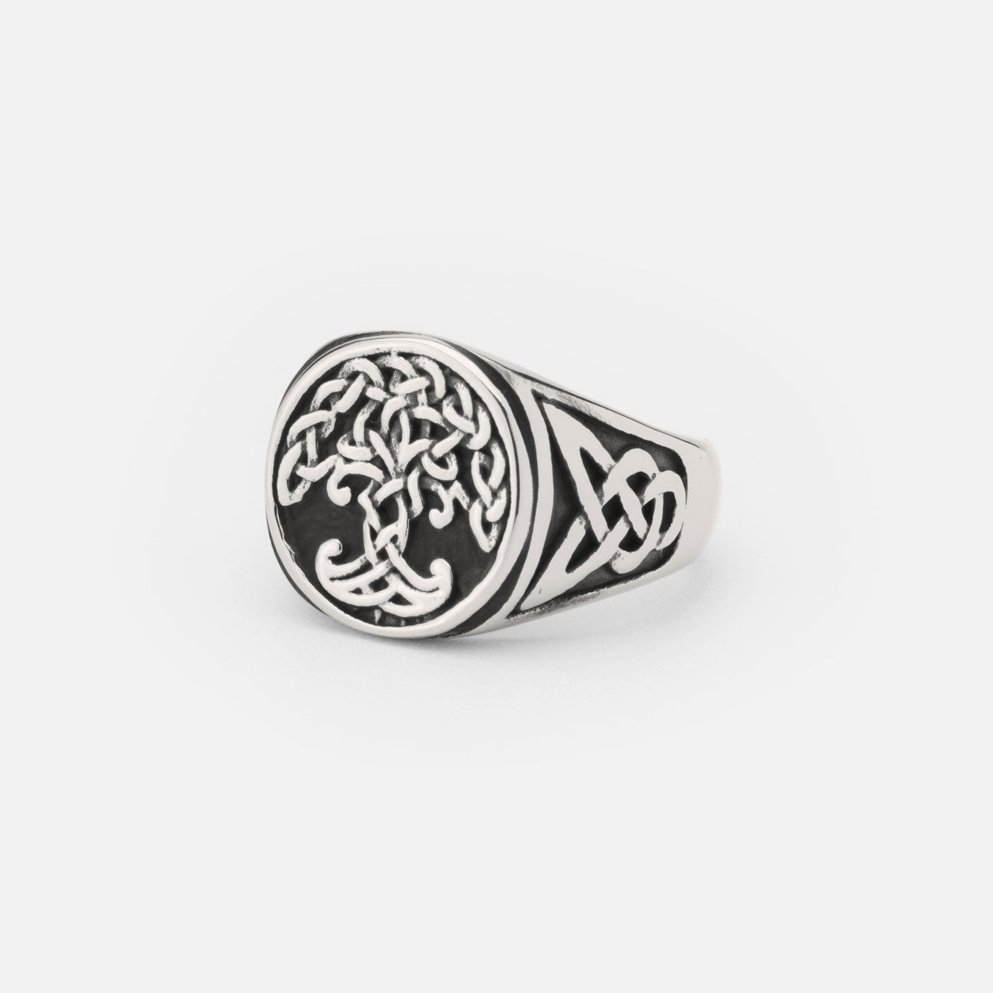 A detailed Yggdrasil ring made of stainless steel, showcasing a central tree of life design surrounded by intricate Celtic knotwork patterns.