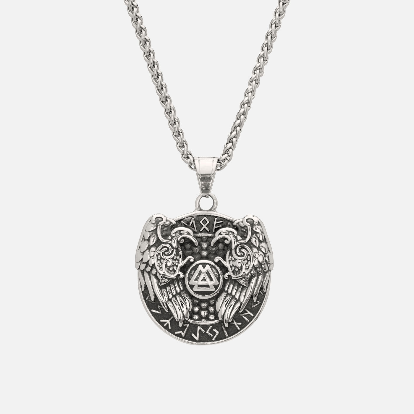 Viking pendant showing Odin’s ravens Hugin and Munin with Valknut symbol and runes, hanging on a stainless steel curb chain.