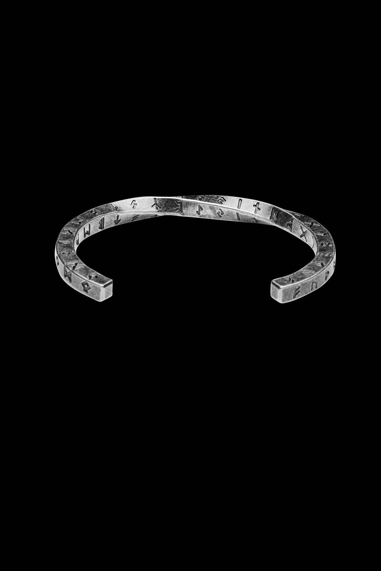 Twisted square design cuff bracelet engraved with Nordic runes representing ancient Norse culture displayed on a transparent background highlighting its Viking-inspired craftsmanship Available at Odin Trinkets