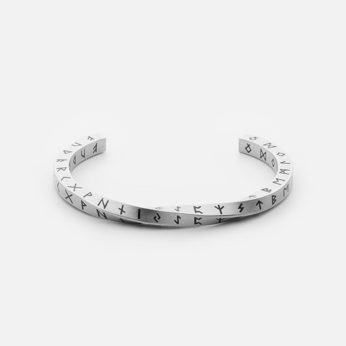 Silver stainless steel Rune Bracelet from Odin Trinkets, featuring engraved Elder Futhark runes in a minimalist open cuff design, symbolizing ancient Norse wisdom and Viking heritage.