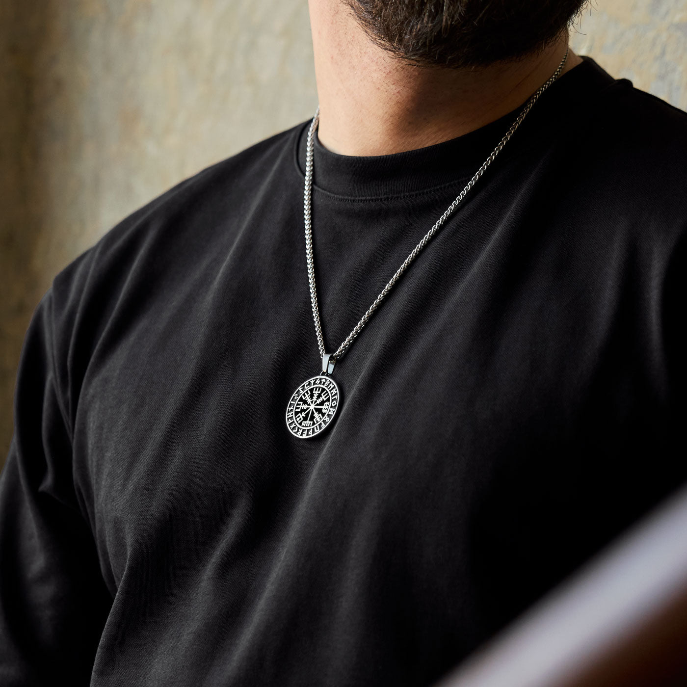 Powerful Vegvisir pendant necklace with Elder Futhark runes, symbolizing guidance and protection, worn confidently as part of an expressive Viking-inspired look – exclusive to Odin Trinkets.