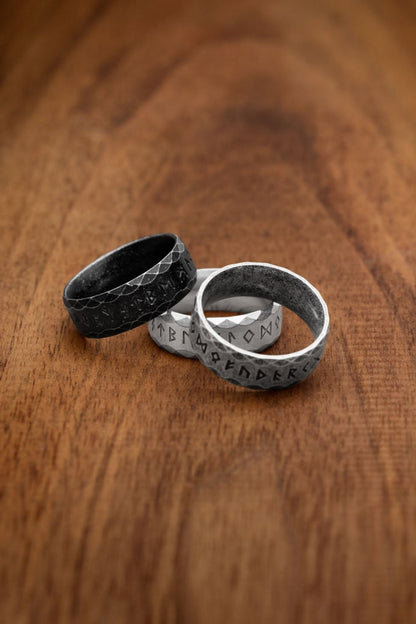 Three stainless steel rings featuring the complete Elder Futhark alphabet, each in a distinct variation. The black ring represents the "Antique" design with a dark, matte finish. The gray ring is the "Retro" style, offering a weathered and rustic appearance. The silver ring, labeled "Silver," showcases a polished stainless steel finish. Perfect for those drawn to Norse mythology and runic inscriptions.