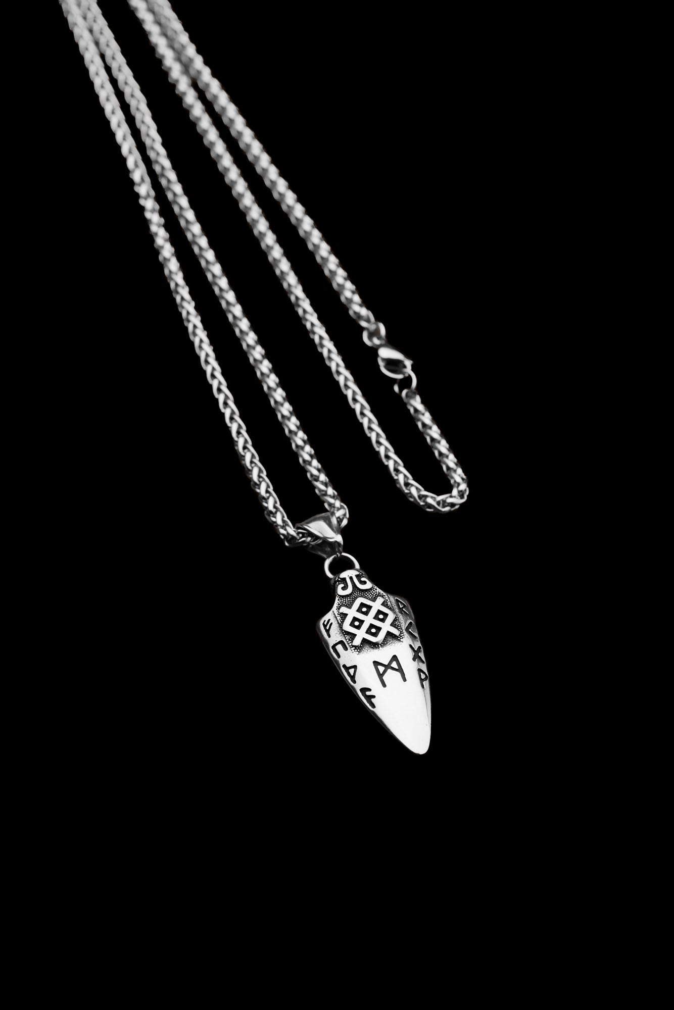 Frontside of the Gungnir necklace featuring a spearhead pendant engraved with Nordic runes and a geometric symbol, displayed on a transparent background. Available at Odin Trinkets.