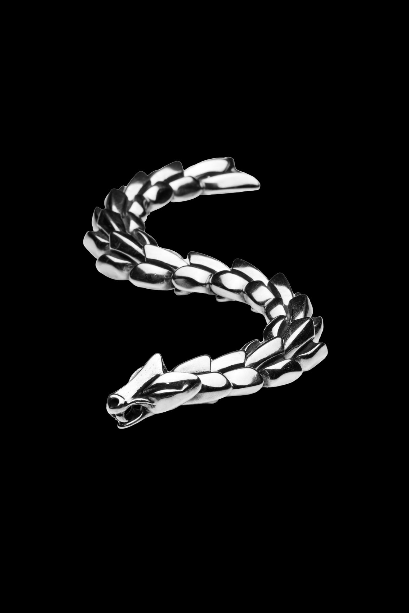 Jormungand bracelet with a serpent-inspired design, featuring a detailed snake head clasp, coiled to resemble the World Serpent from Norse mythology, displayed on a transparent background. Available at Odin Trinkets.