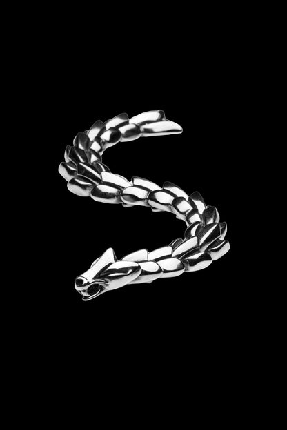 Jormungand bracelet with a serpent-inspired design, featuring a detailed snake head clasp, coiled to resemble the World Serpent from Norse mythology, displayed on a transparent background. Available at Odin Trinkets.