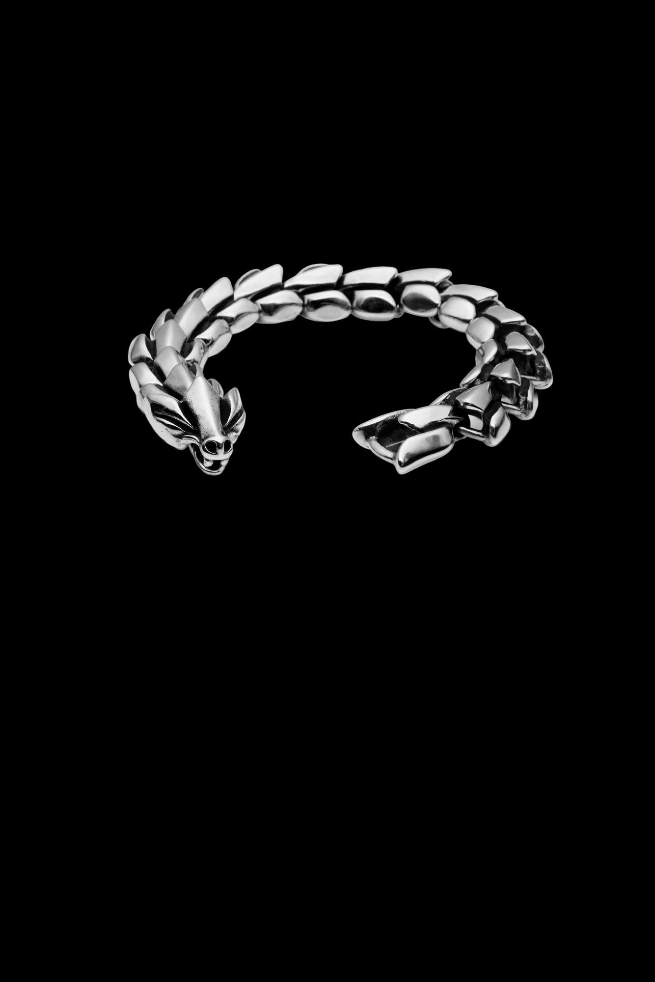 Jormungand bracelet featuring a serpent-inspired design with a detailed snake head clasp, representing the World Serpent from Norse mythology, displayed on a transparent background. Available at Odin Trinkets.