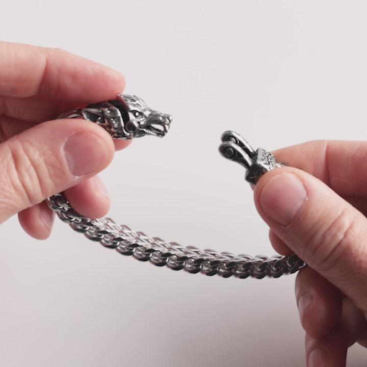 Close-up video of a stainless steel Fenrir bracelet, showcasing its intricate wolf head clasp and bold Viking-inspired design. This Norse mythology bracelet symbolizes strength and ferocity, captured in detail to highlight its craftsmanship – a statement piece from Odin Trinkets.