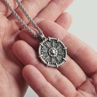 Odin Trinkets close-up video of silver stainless steel Viking necklace featuring the Helm of Awe symbol on shield design, powerful Norse mythology inspired jewelry for men