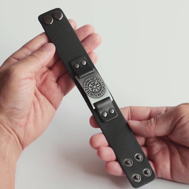 Close-up video of Odin Trinkets black leather bracelet with detailed Vegvisir compass design, inspired by Norse mythology and worn as a Viking symbol of protection and guidance