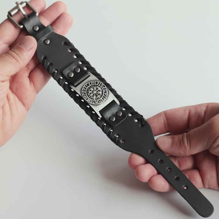 Close-up video of Odin Trinkets close-up video of black leather Viking bracelet featuring the Vegvisir compass symbol from Norse mythology, highlighted with an adjustable buckle closure